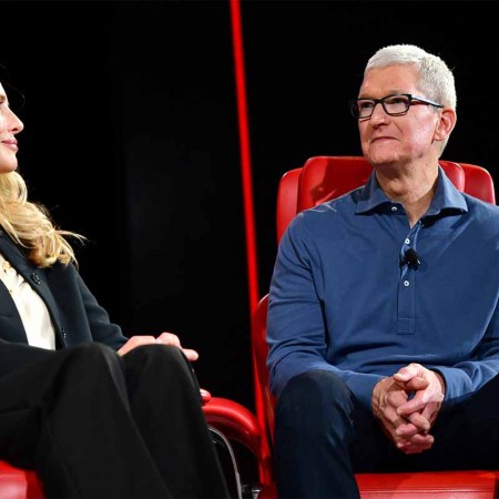 Laurene Powell Jobs and Chief Executive Officer of Apple Tim Cook speak onstage during Vox Media's 2022 Code Conference