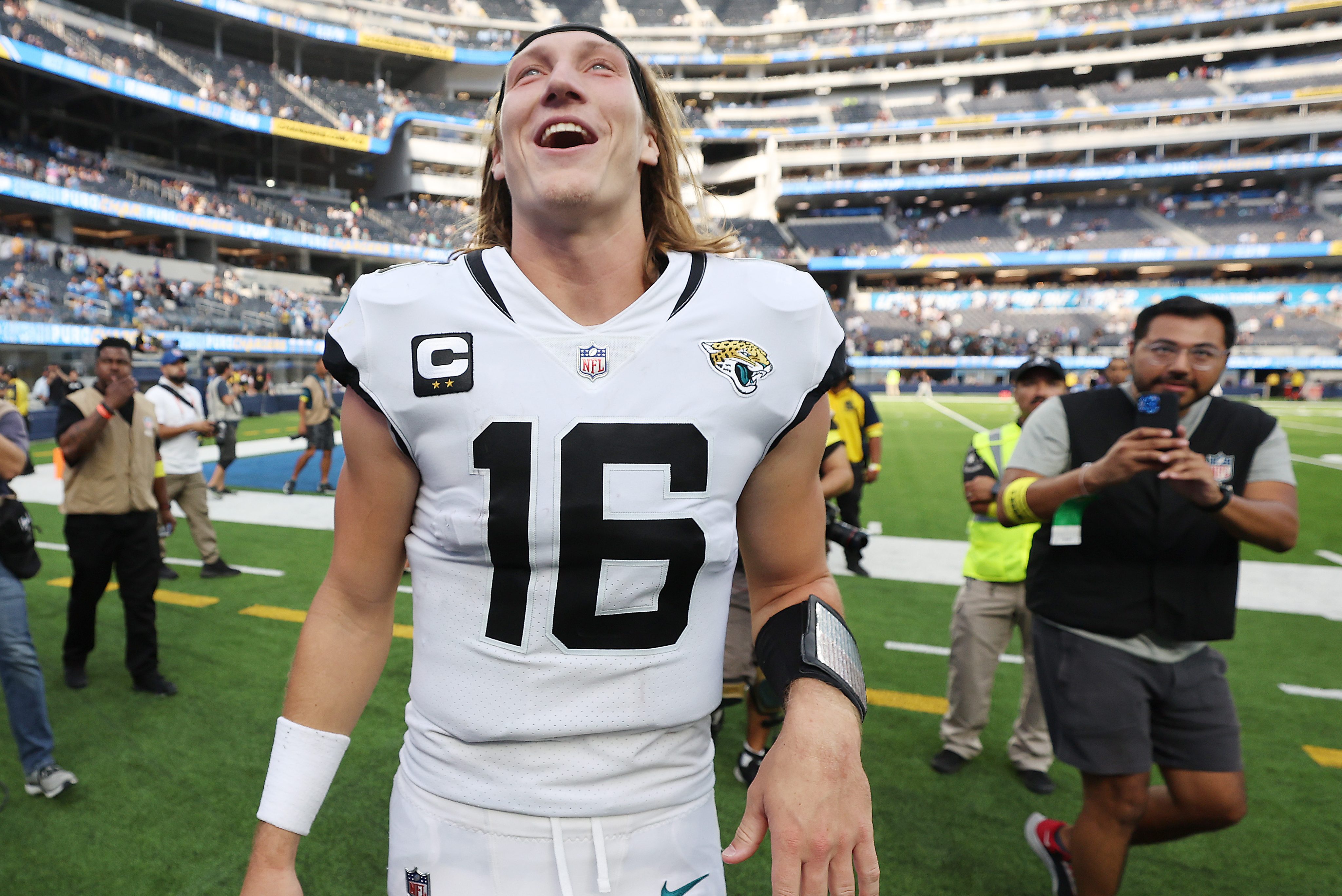 Trevor Lawrence leaves the field after his team's 38-10 win against the Chargers in LA.