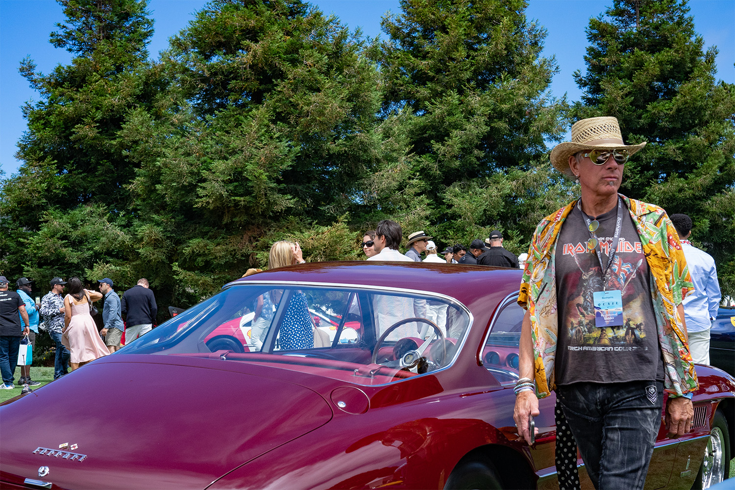 Spectator beside a Ferrari at Rolex Monterey Motorsports Reunion