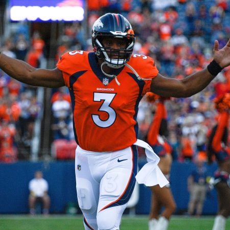 Denver Broncos quarterback Russell Wilson runs onto the field before a preseason game against the Minnesota Vikings.