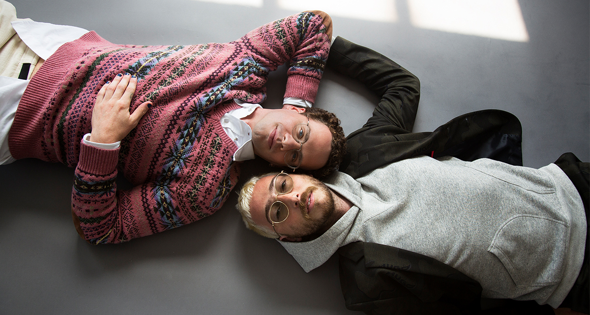 Max Kakacek and Julien Ehrlich of the band Whitney lying on the ground