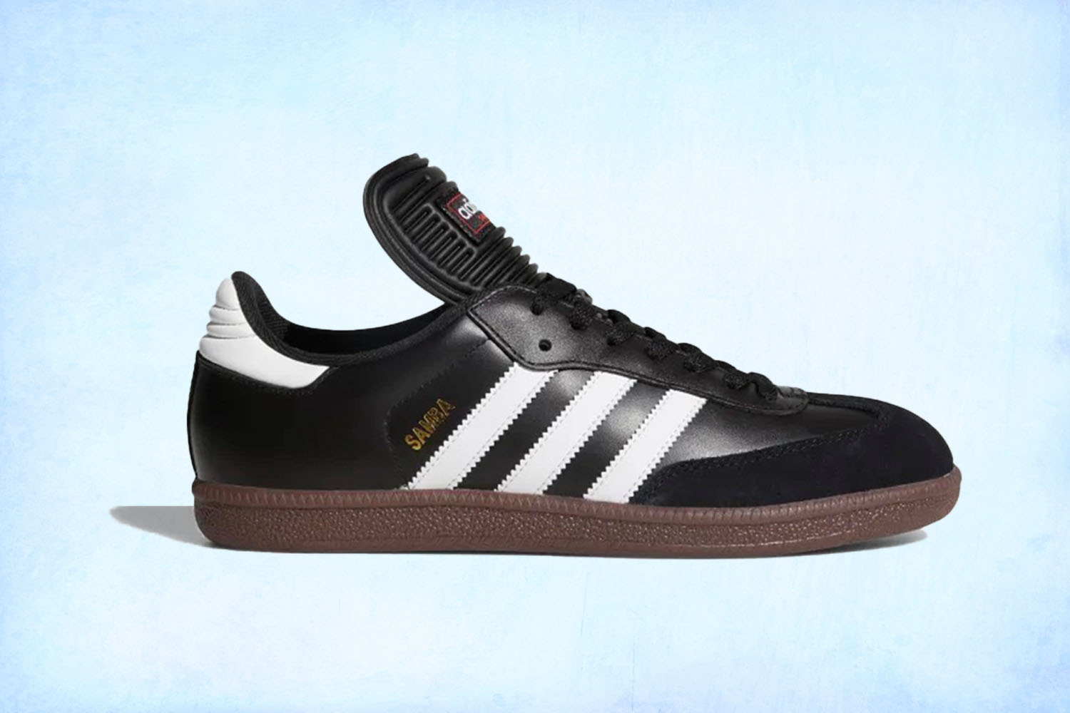 a black Adidas Samba sneaker on a light blue background