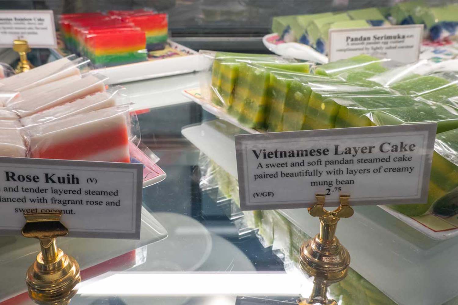 A display case with three different cakes