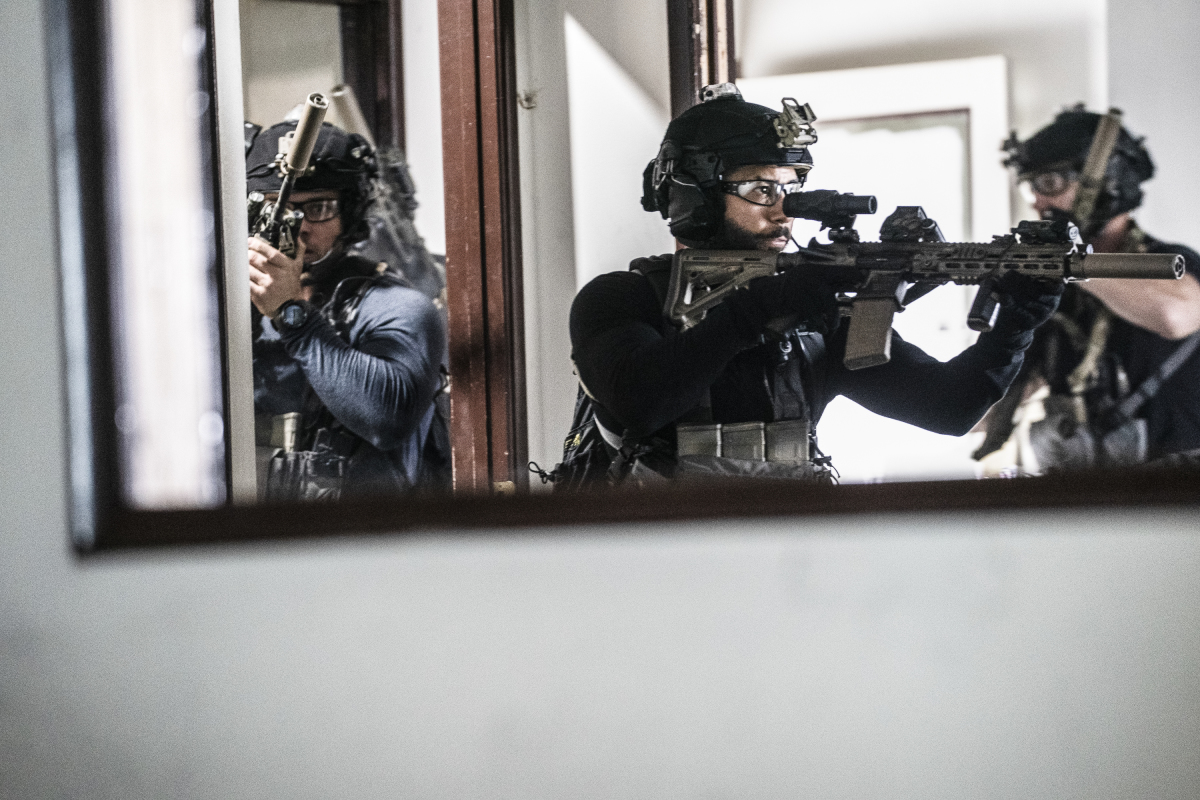 A still from the television show "SEAL Team," in which special ops forces enter a room with high-powered guns.