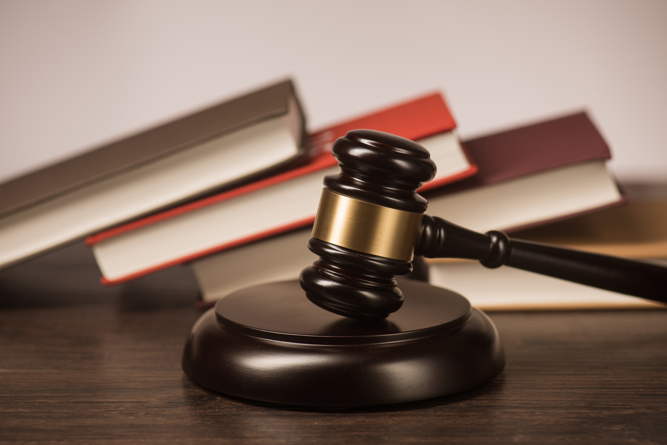 A gavel with books behind it