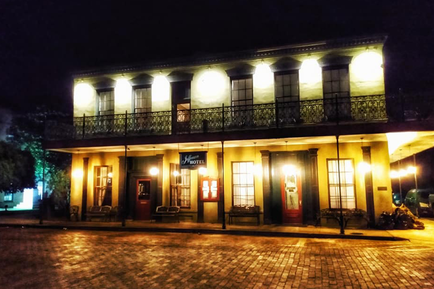 The Historic Jefferson Hotel in Texas illuminated at night, one of the most haunted places in the state