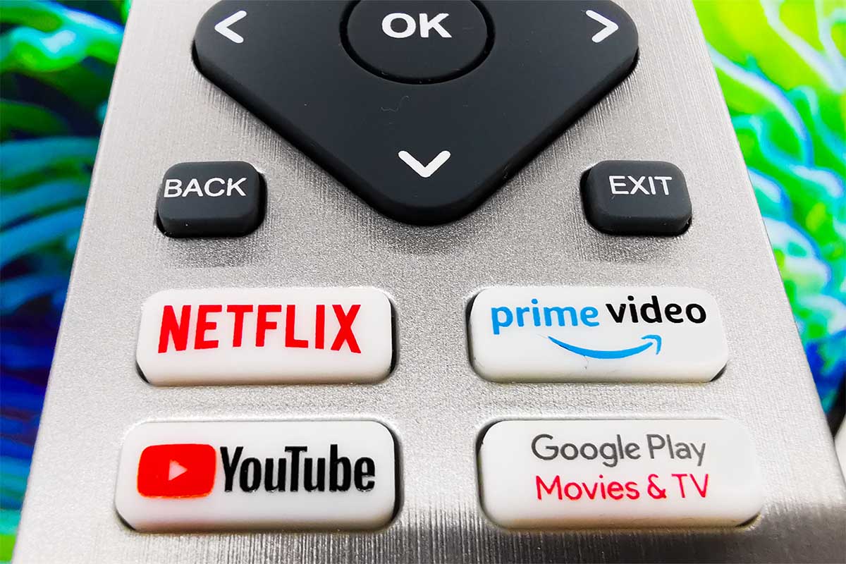 A detail of TV remote control with streaming platform buttons. We look at how Netflix and other streaming services might be immune to inflation.