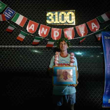 A man posing after winning an ultramarathon.