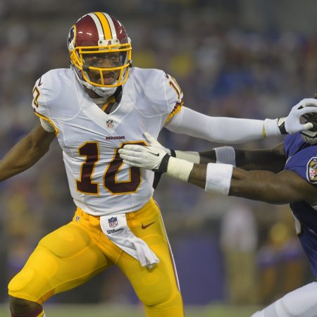 Ex-Washington quarterback Robert Griffin III pushes off a Baltimore during a road game.