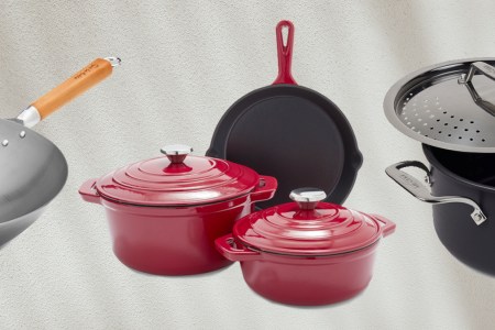 A set of cast iron from Sur La Table, a carbon steel wok and stockpot from All-Clad, all discounted during Sur La Table's Semi-Annual Cookware Sale