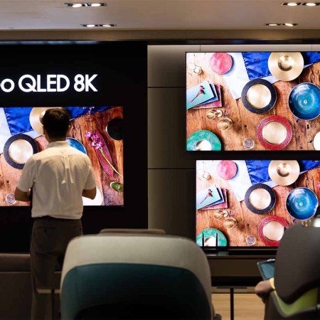 A customer looks at a Samsung Electronics Co. QLED 8K television at the company's D'light flagship store in Seoul, South Korea, on Tuesday, July 5, 2022. The energy consumed by 8K tvs is an issue in the European Union, which may effectively ban these sets starting in March.