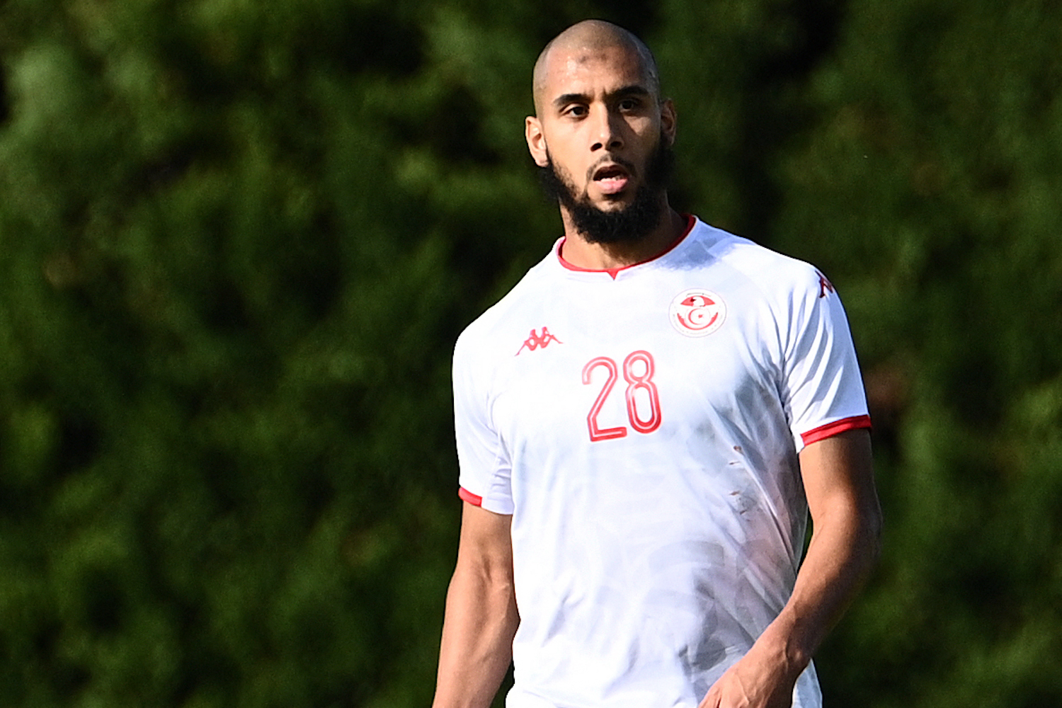 a soccer player wearing a white jersey