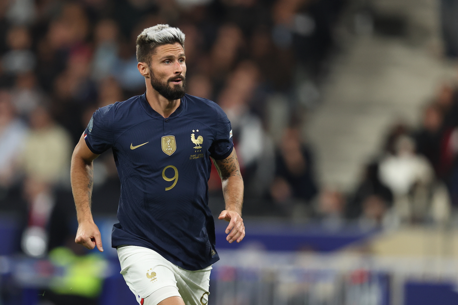 a french soccer player in a blue jersey