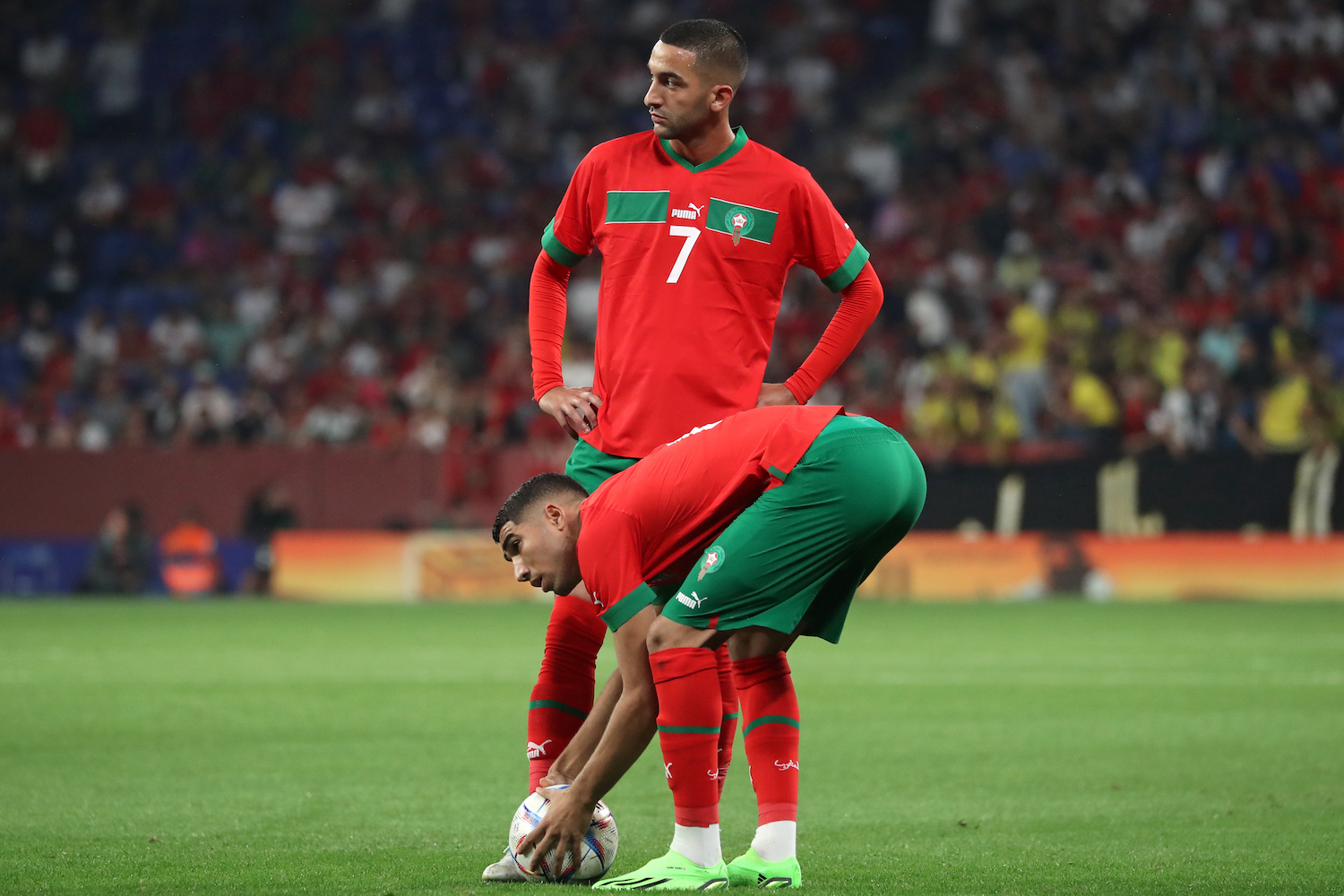 two players wearing red soccer jerseys.