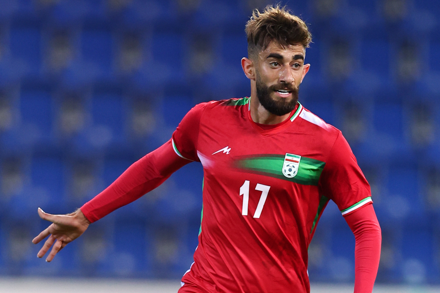 a soccer player wearing a red jersey