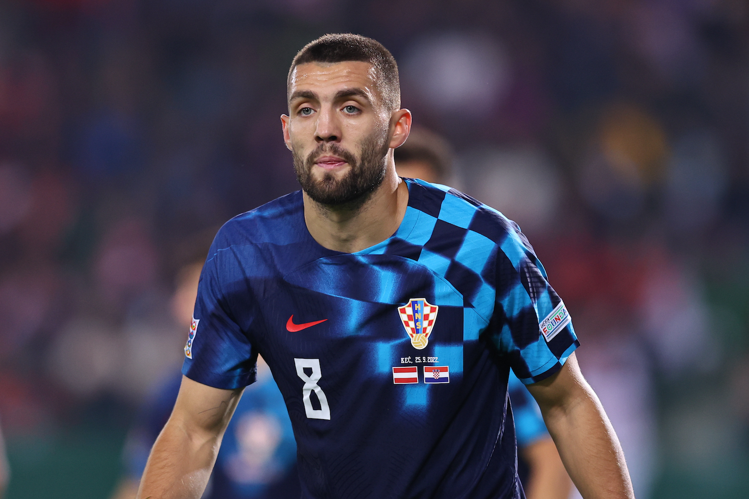 a player in a navy checked soccer jersey