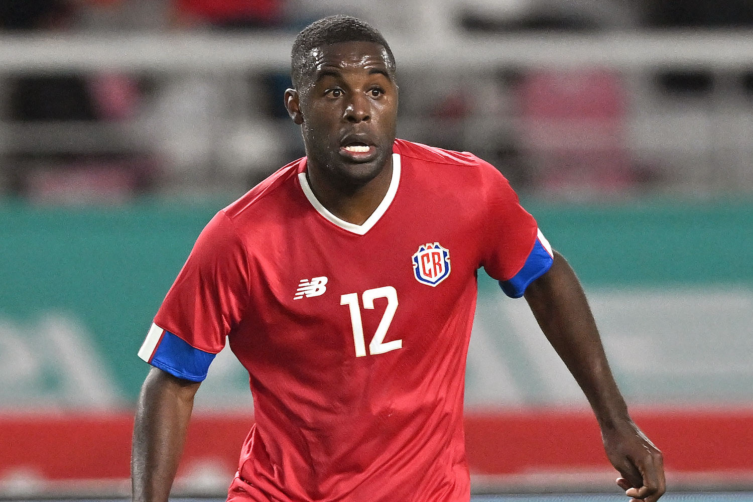 a soccer player in a red soccer jersey