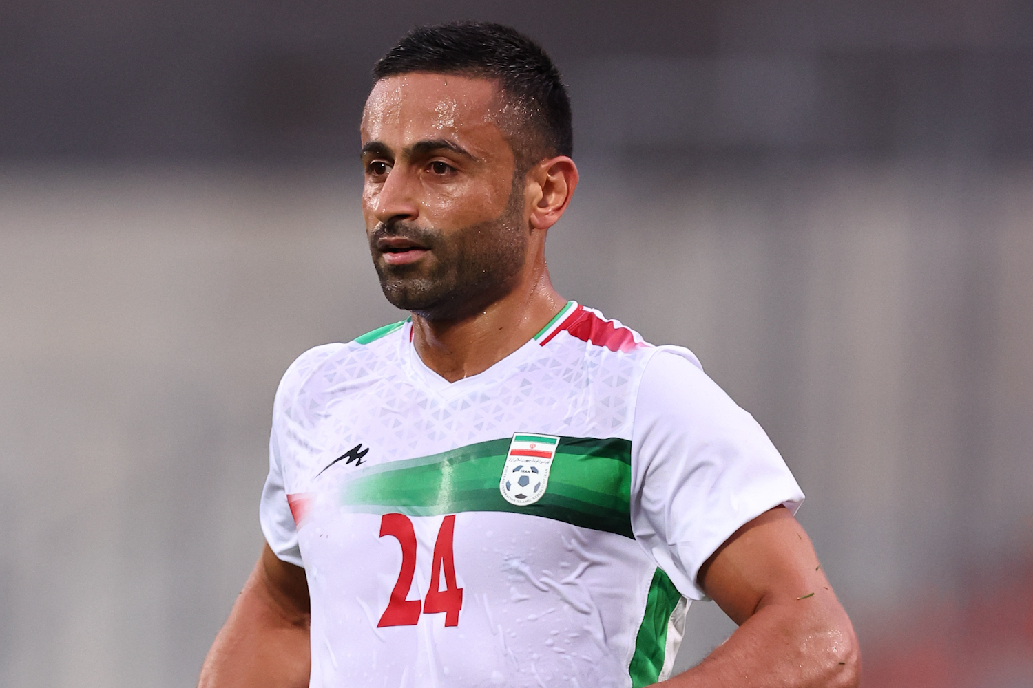 a soccer player wearing a white jersey