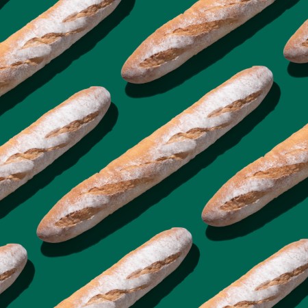 Baguette Long Loaf on Solid Green Colored Background Arrangement Pattern