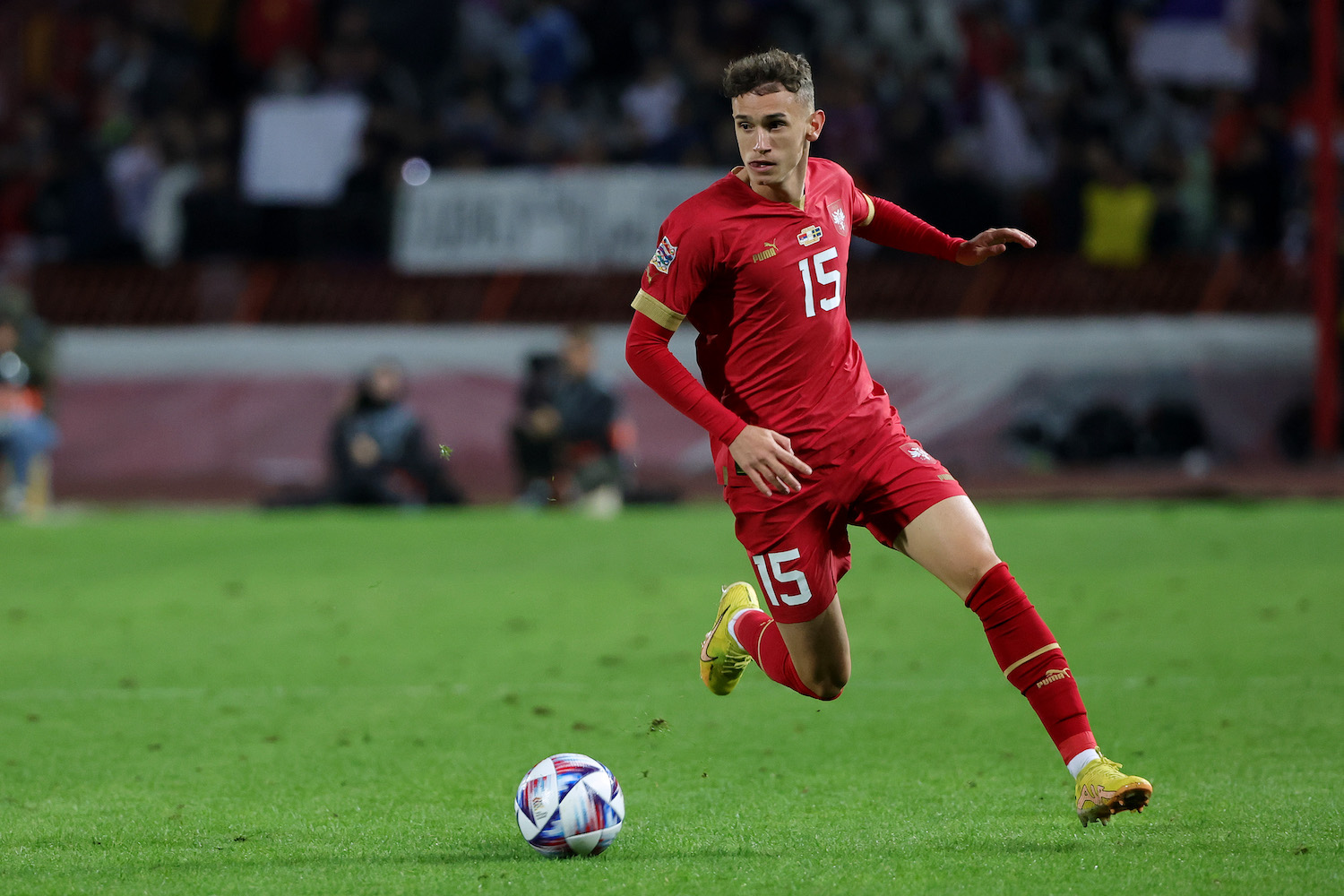 a soccer player wearing a red jersey