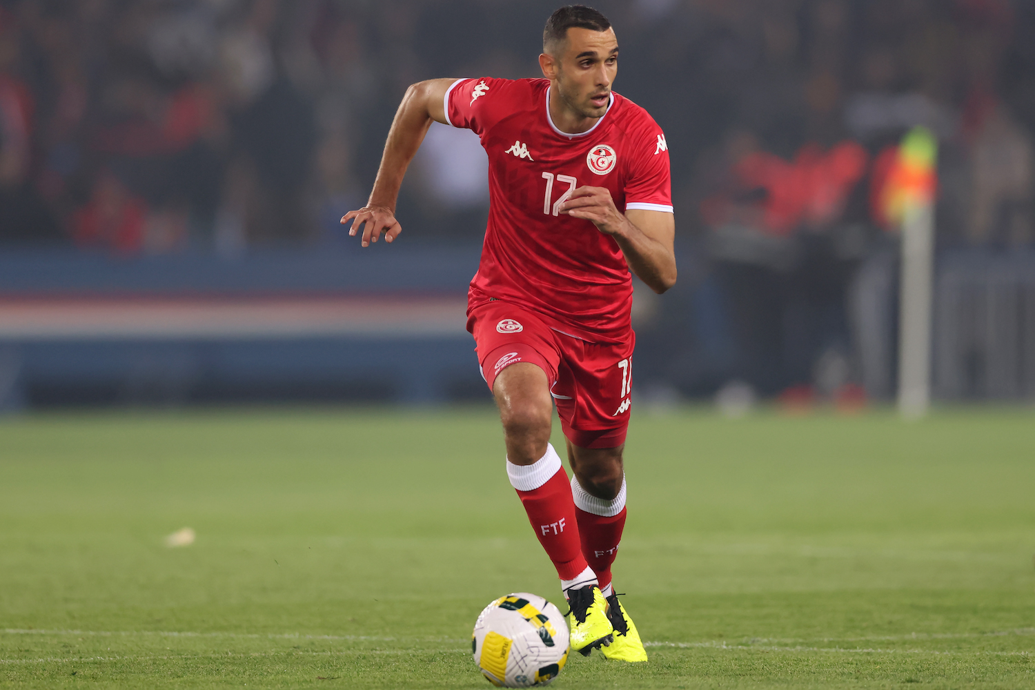 a soccer player wearing a red jersey