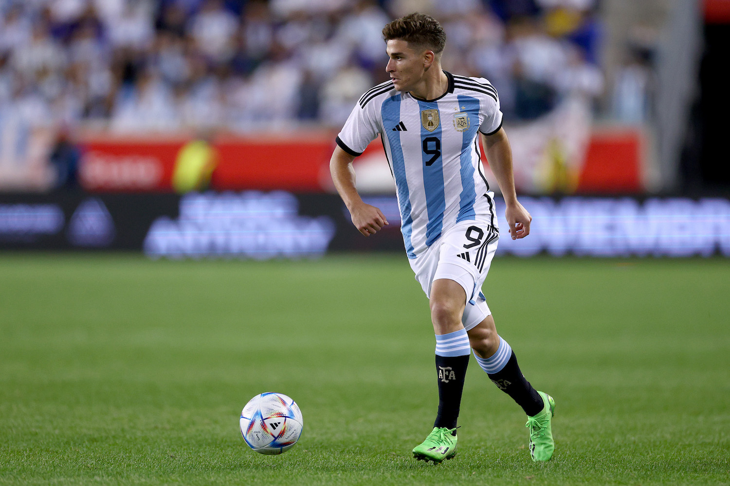 a player in a striped white and blue soccer jersey