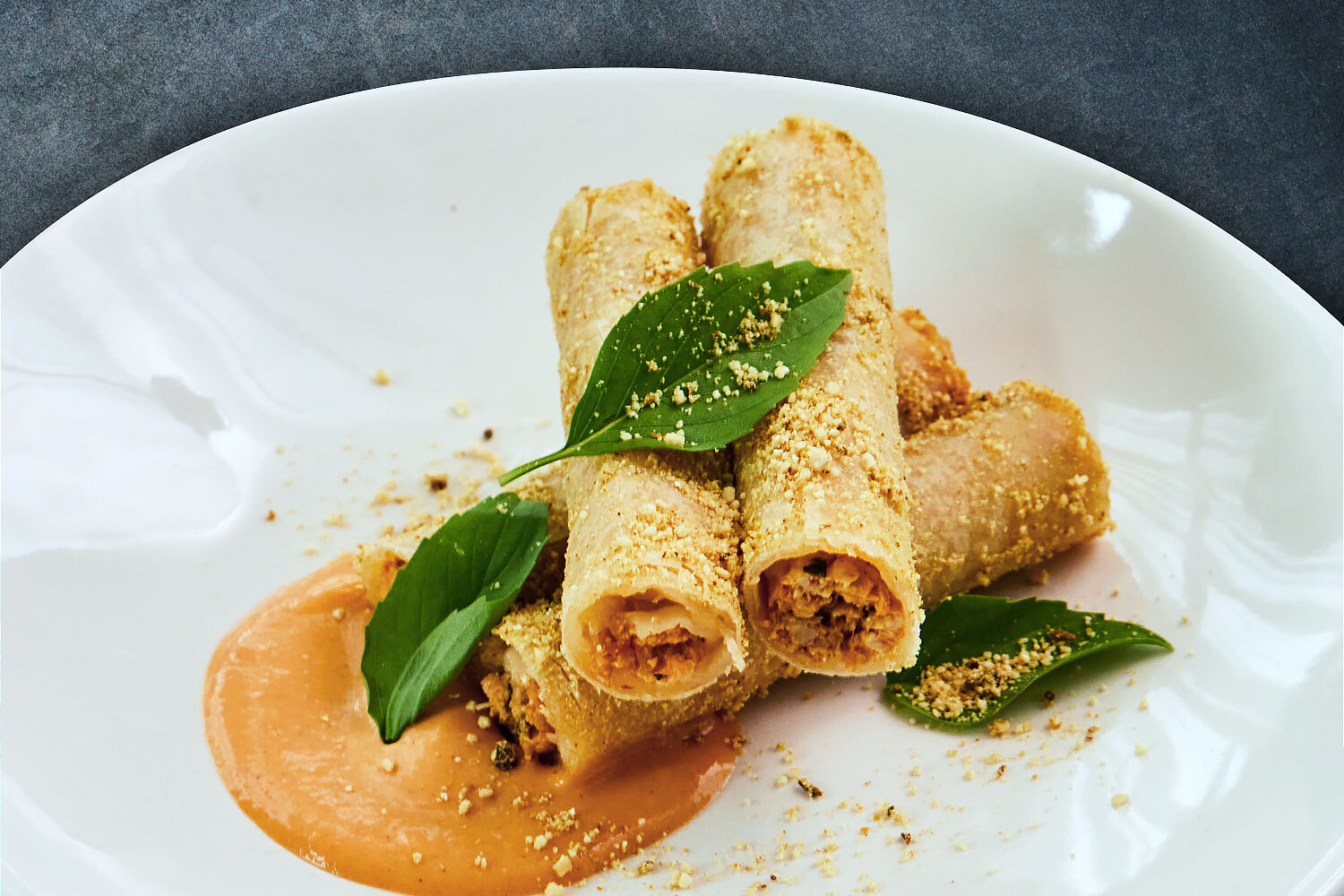 country captain spring rolls on a white plate at fleeting restaurant in savannah