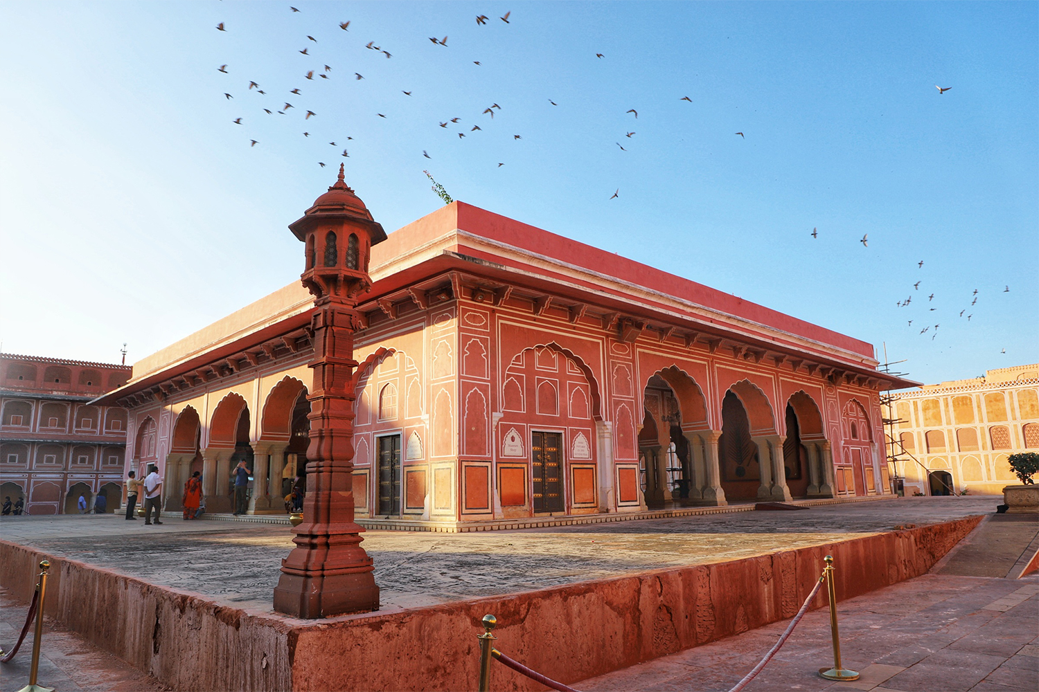 Birds flying in a blue sky above the Pink City of Jaipur, India, one of the stops on our travel writer's tour of India and Nepal