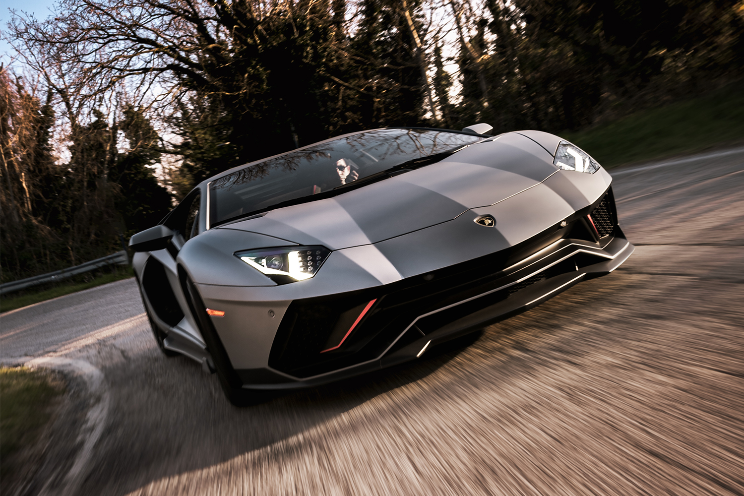 A man driving a Lamborghini Aventador Ultimae, the last Lambo with a naturally-aspirated V12 engine