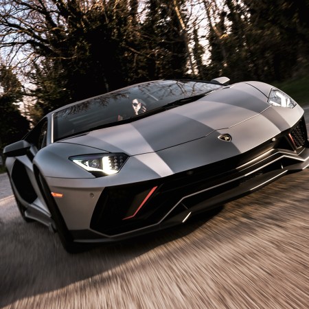 A man driving a Lamborghini Aventador Ultimae, the last Lambo with a naturally-aspirated V12 engine