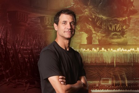 Ramin Djawadi, composer of the "Game of Thrones" series, pictured in front of scenes from "House of the Dragon"