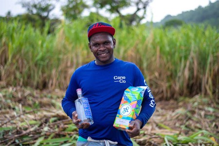 A worker holding a bottle of Renegade Rum in Grenada. The rum brand has made a large investment into the island with its new distillery.