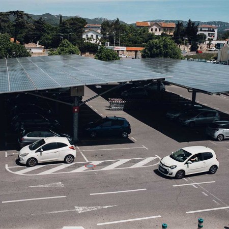 Automobiles under solar canopies at a GreenYellow renewable energy site in the parking lot of a Geant Casino hypermarket, operated by Casino Guichard Perrachon SA, in Marseille, France, on Thursday, May 20, 2021. New legislation means that large car parks in France will be required to be covered by solar panels.