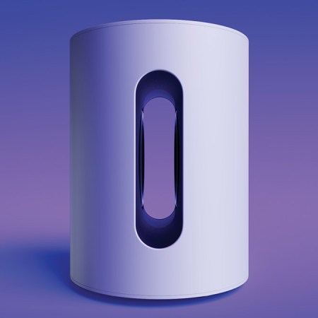 A white Sonos Sub Mini on a purple background. The mini is a new compact subwoofer.