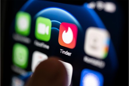 A hand taps on the Tinder app installed on a smartphone. The dating app launched on September 12, ten years ago. The app's "Year in Swipe" report was just released