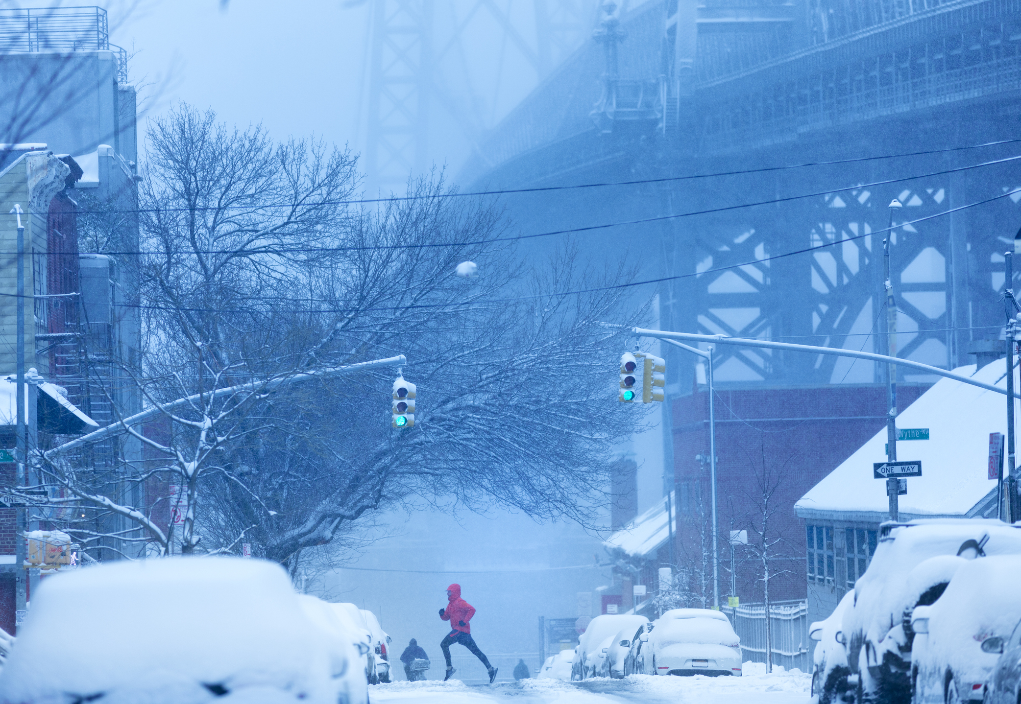 A man running through the snow in New York City.