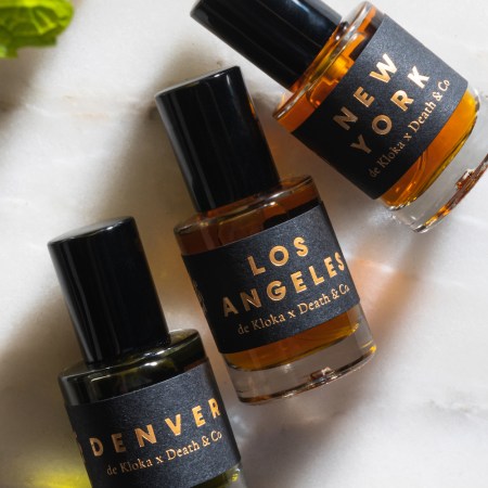 three fragrances from death & co on a marble background