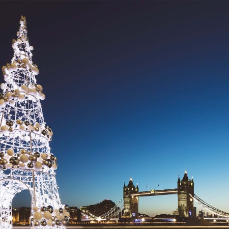 UK, London, Tower Bridge at twilight with illuminated Christmas tree in the foreground