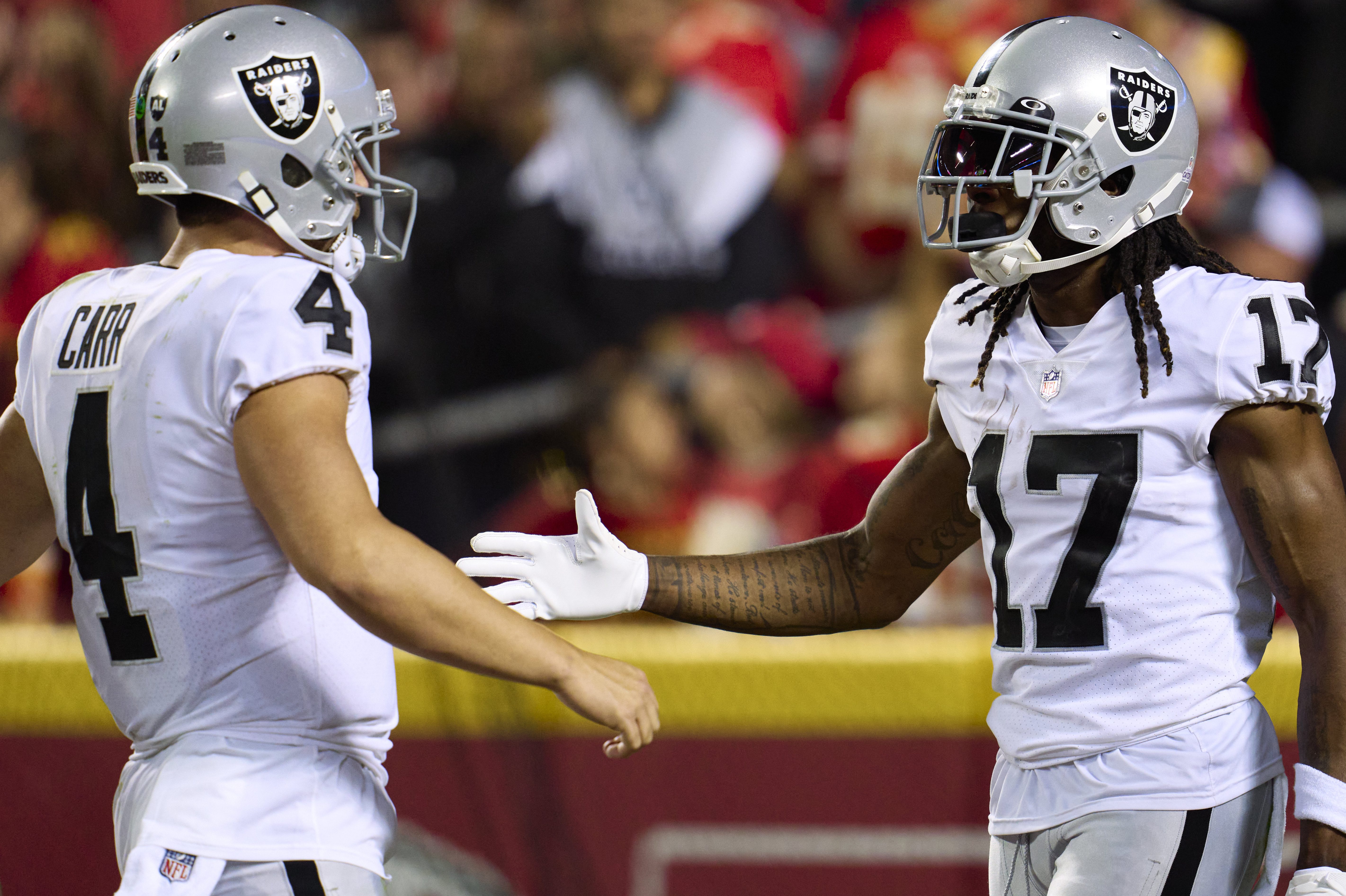 Davante Adams celebrates with Derek Carr after scoring a touchdown.