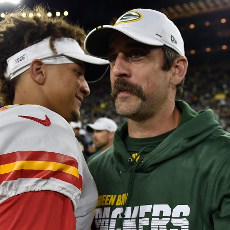 Aaron Rodgers shakes hands with Patrick Mahomes after a preseason game.