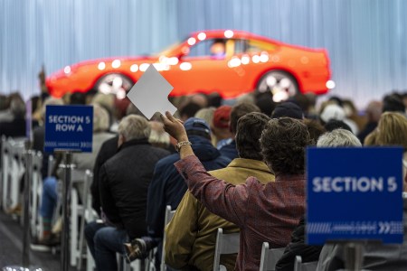 An attendee bidding at Gooding & Company’s Pebble Beach auction in August. According to Hagerty, collector cars are finally cooling off.