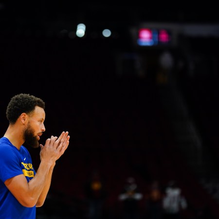 Steph Curry seen against a black background.