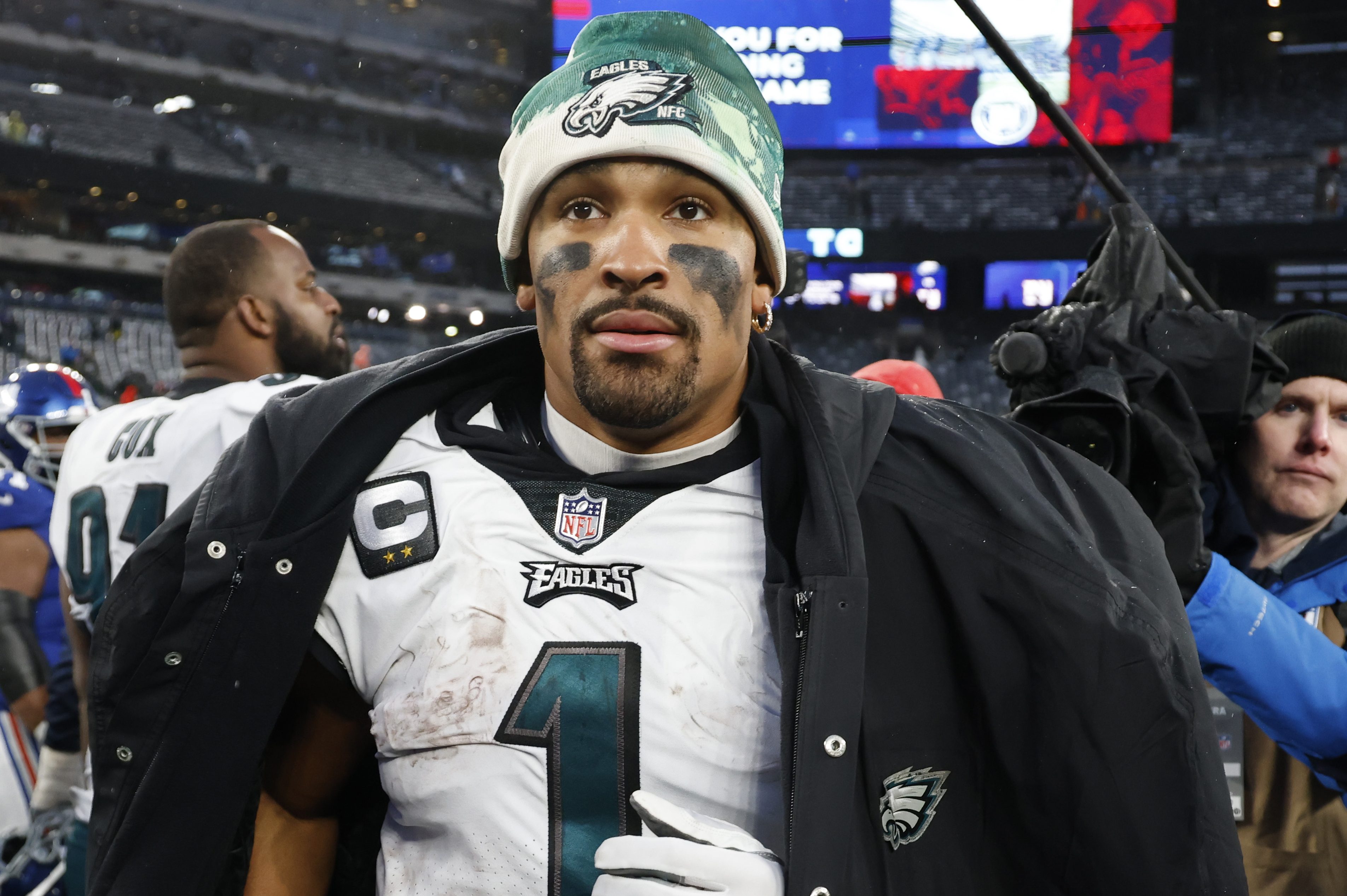 Jalen Hurts walks off the field after beating the New York Giants.