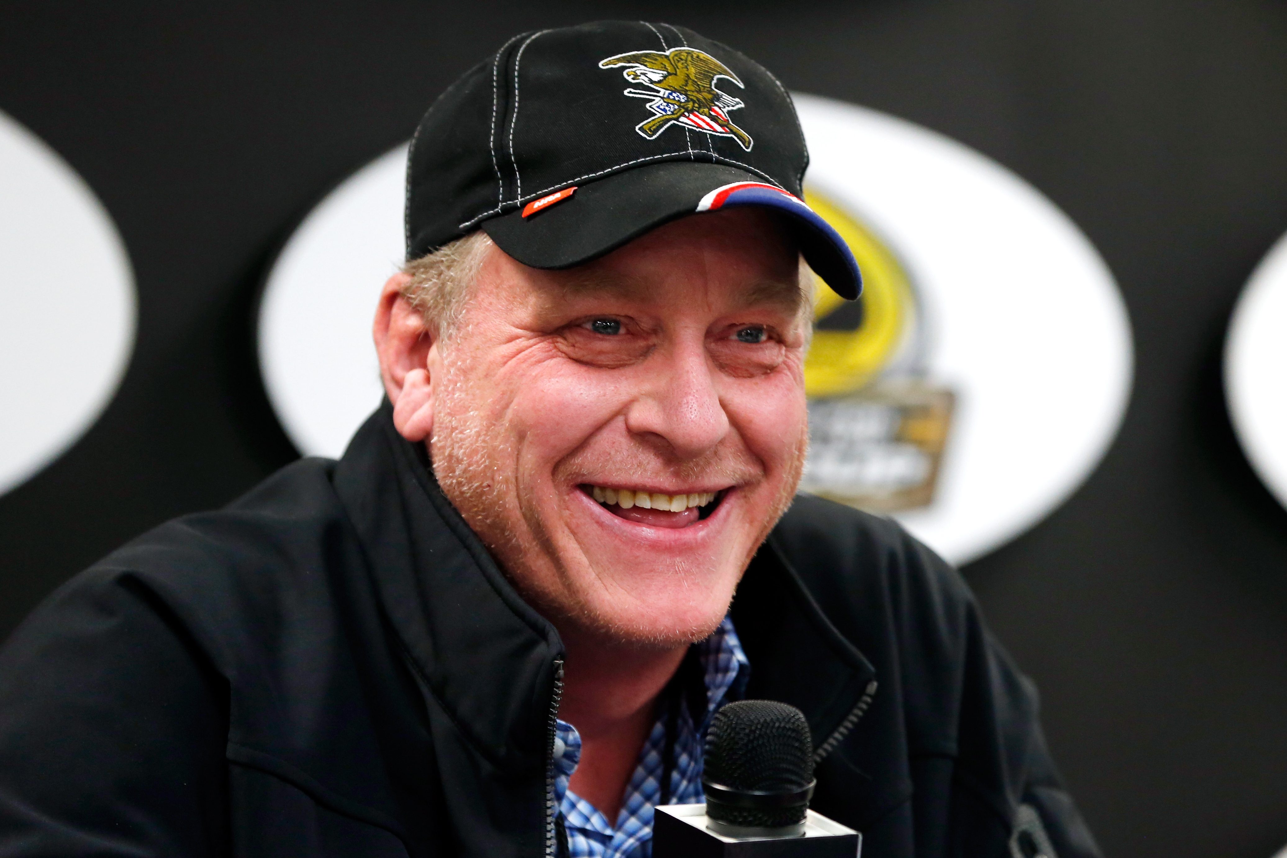 Ex-MLB player Curt Schilling speaks with the media before a NASCAR race.