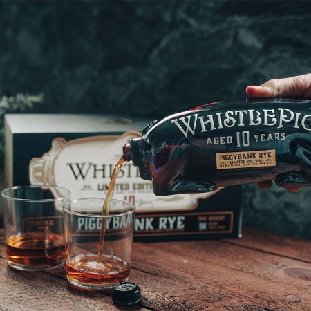 WhistlePig 10 Limited Edition PiggyBank being poured on a table. The uniquely shaped decanter means you're literally pouring from the pig's rear.