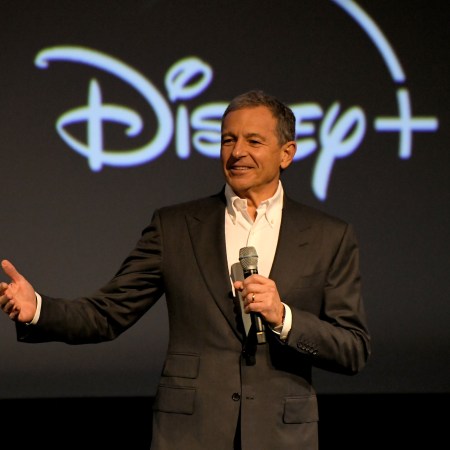 CEO Bob Iger speaking in front of a Disney+ logo