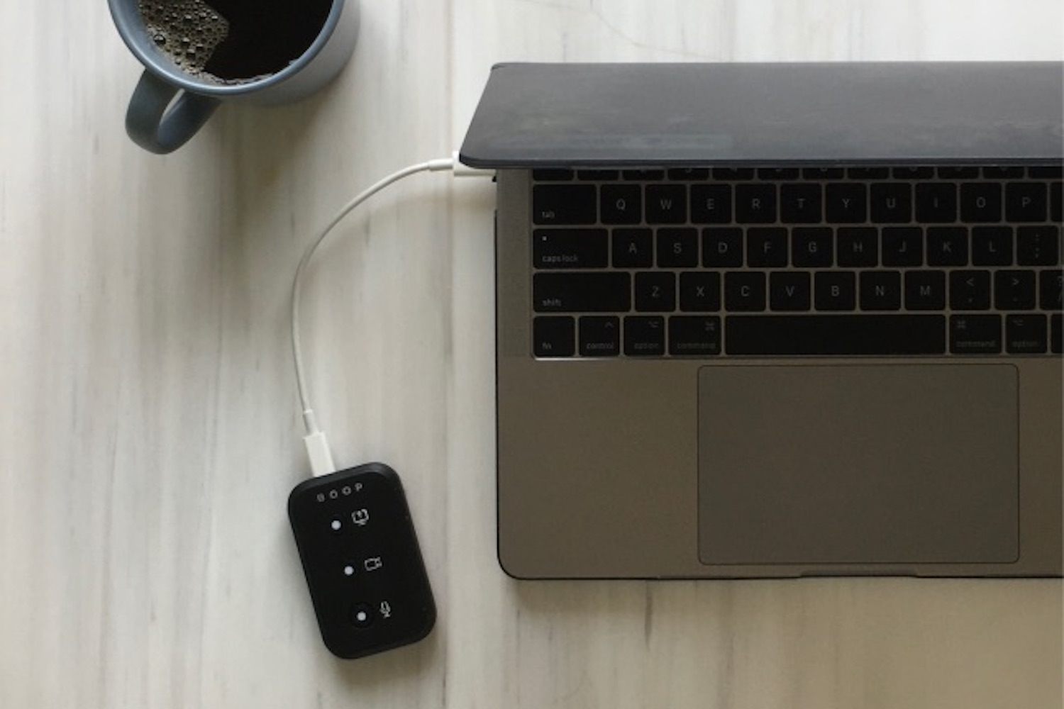 a Boop device connected to an Apple laptop on a desk