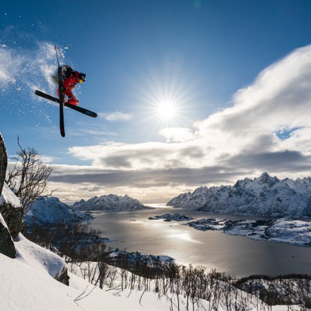 Skier Adam Ü jumping off a cliff in Norway's Lofoten Islands