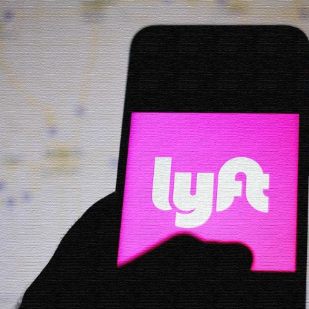 The Lyft logo is seen displayed on a smartphone.