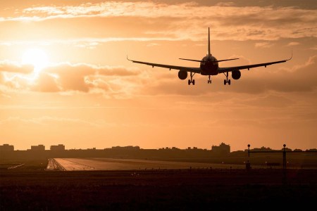 An airplane flying at dusk